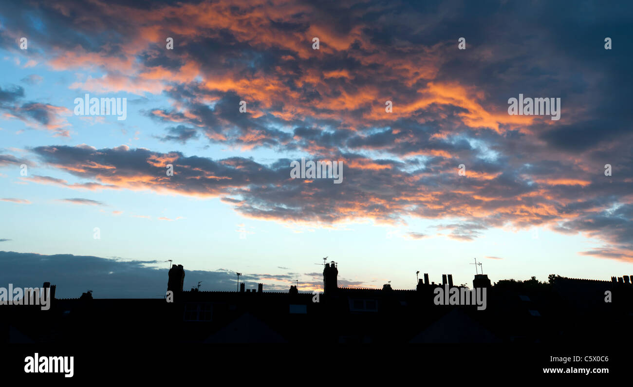 Sunset over rooftops with chimney pots Stock Photo