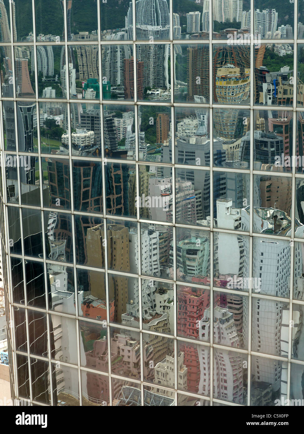 View looking down on Hong Kong appartment blocks reflected in the glass windows of a tower block Stock Photo