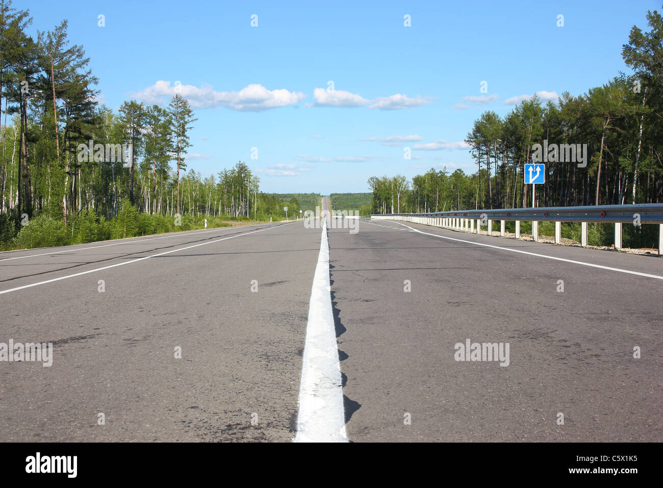 Asphalt road and sky with clouds Stock Photo - Alamy