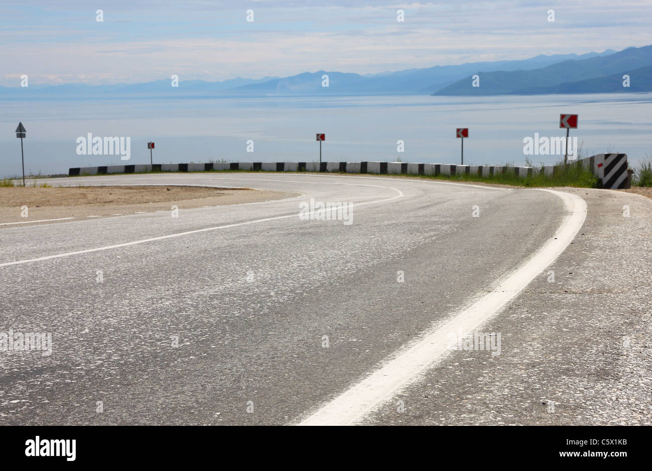 Asphalt road and sky with clouds Stock Photo - Alamy