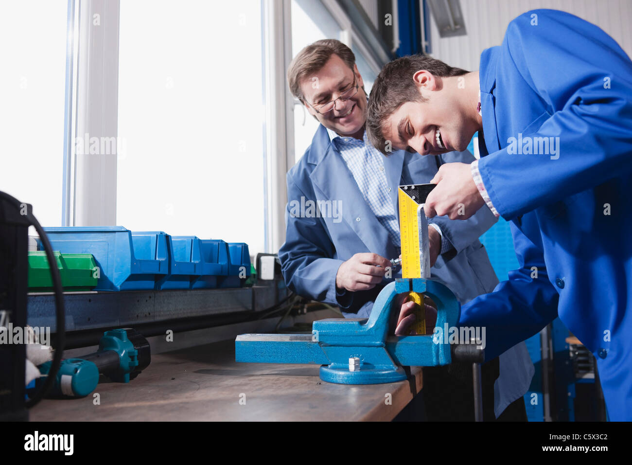 Germany, Neukirch, Apprentice working on bench vice Stock Photo Alamy