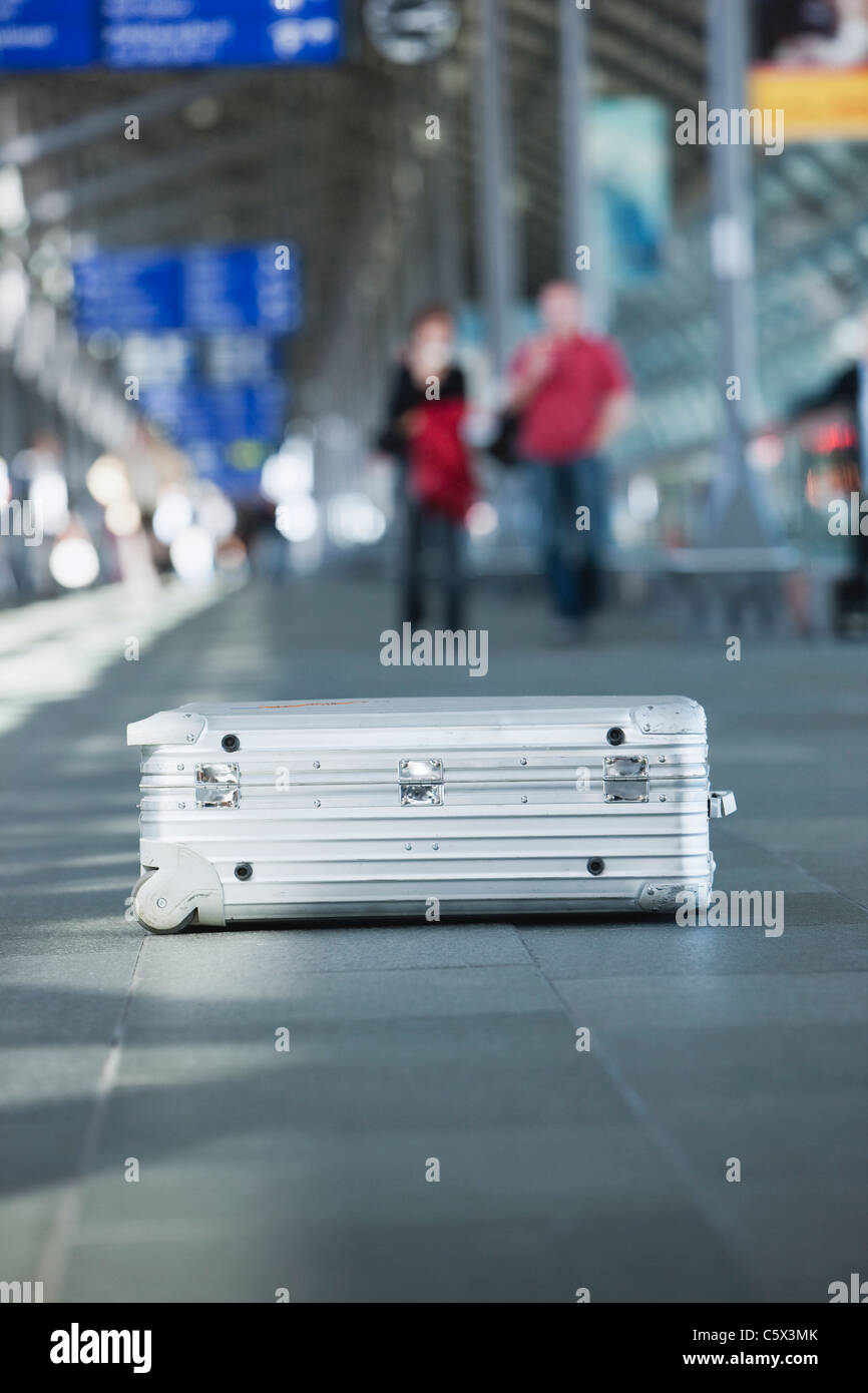 Germany, Leipzig-Halle, Airport, Suitcase, People in background Stock Photo
