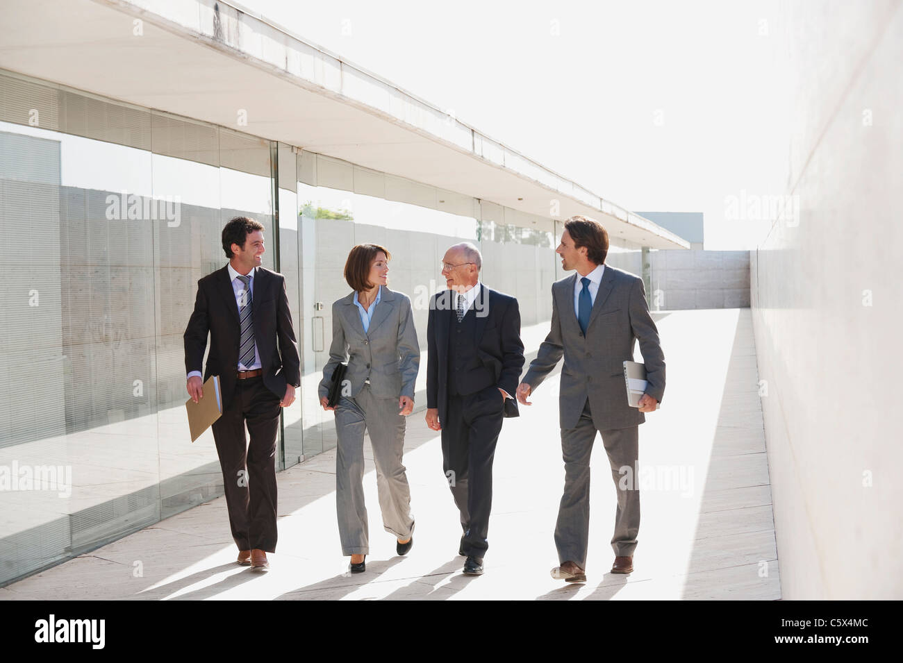 Spain, Mallorca, Business people walking together Stock Photo - Alamy