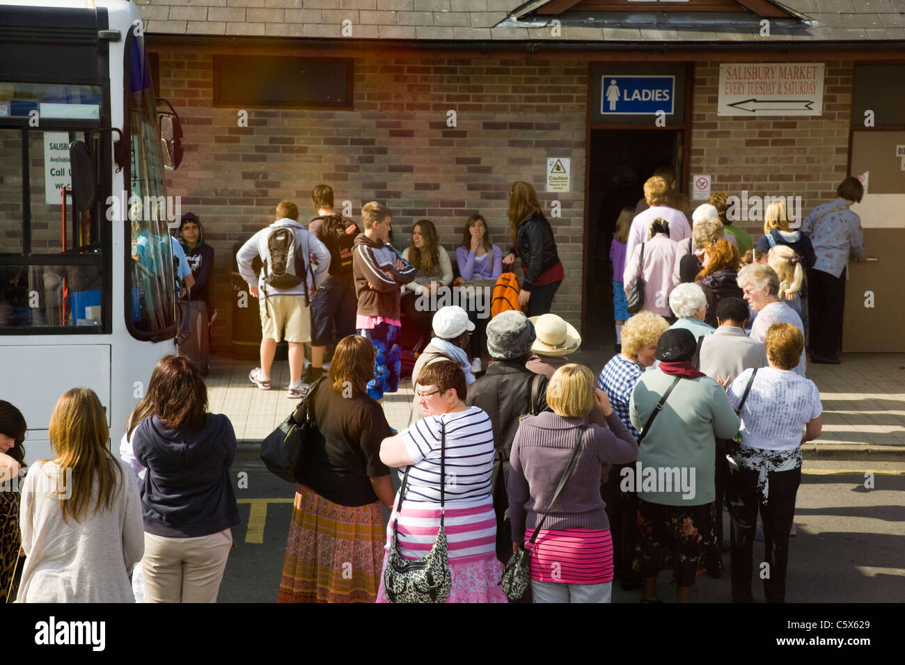 Crowds and long queue outside a ladies toilet in a service station Stock Photo