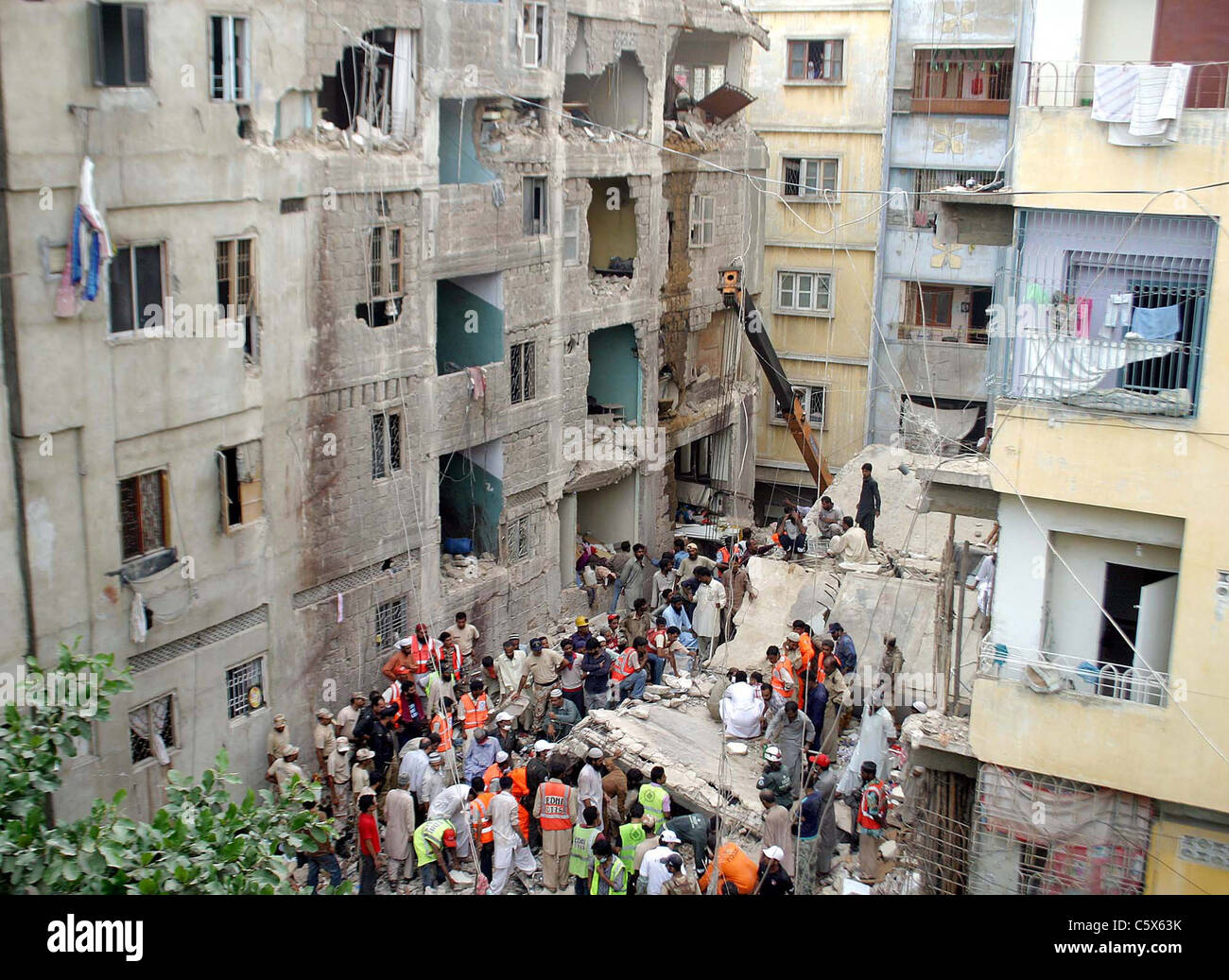 Volunteers busy in rescue operation at the site of building collapse ...