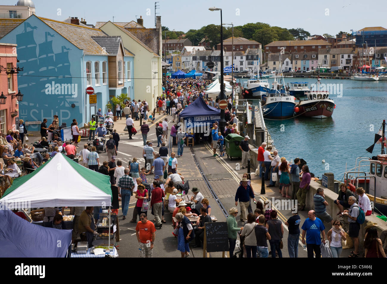 Crowds of people in the harbour attending the Weymouth food festival