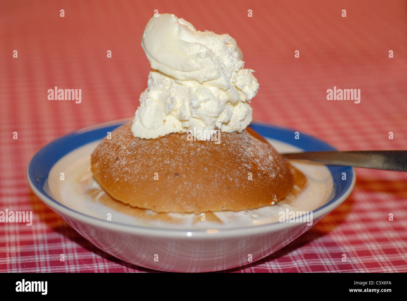 Bun with whipped cream. Stock Photo