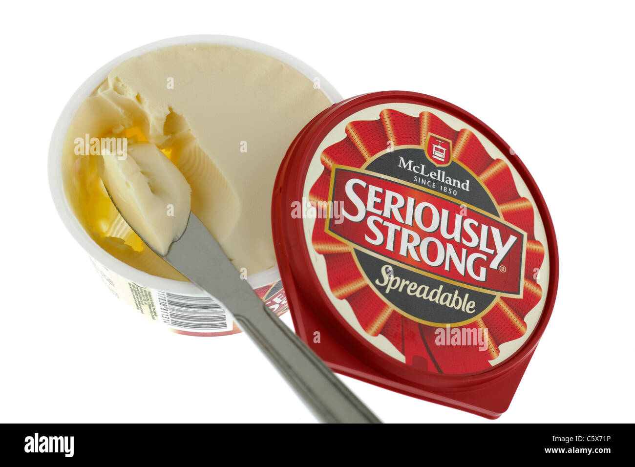 Tub of Spreadable Seriously Strong Mcelland cheese spread and a portion on a knife. Stock Photo