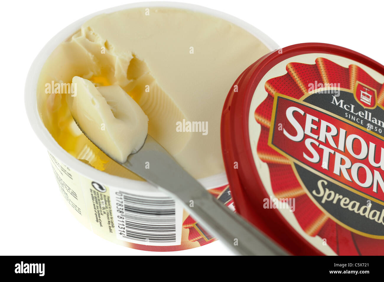 Tub of Spreadable Seriously Strong McLelland cheese spread and a portion on a knife. Stock Photo