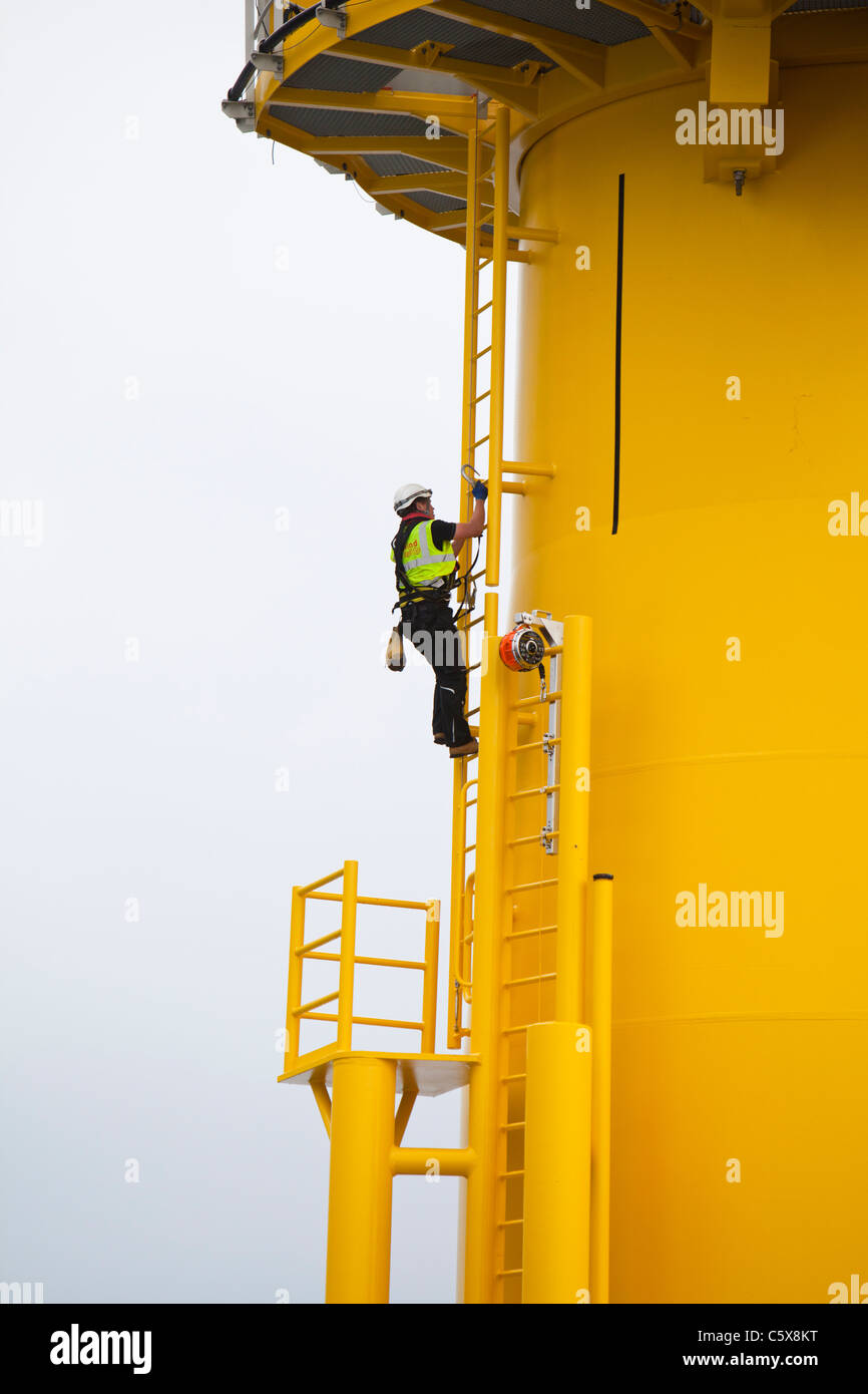 Offshore workers working on a wind turbine at the Walney Offshore windfarm project, off Barrow in Furness, Cumbria, UK. Stock Photo