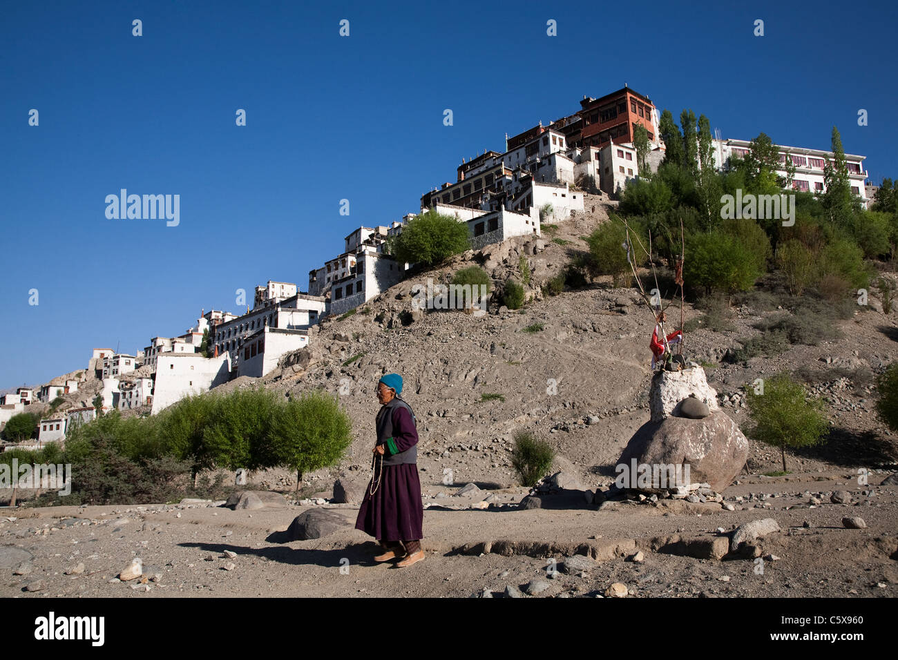 Ladakhi Woman crossing Thiksey Gompa / monastery in Ladakh region of Jammu & Kashmir. India Stock Photo