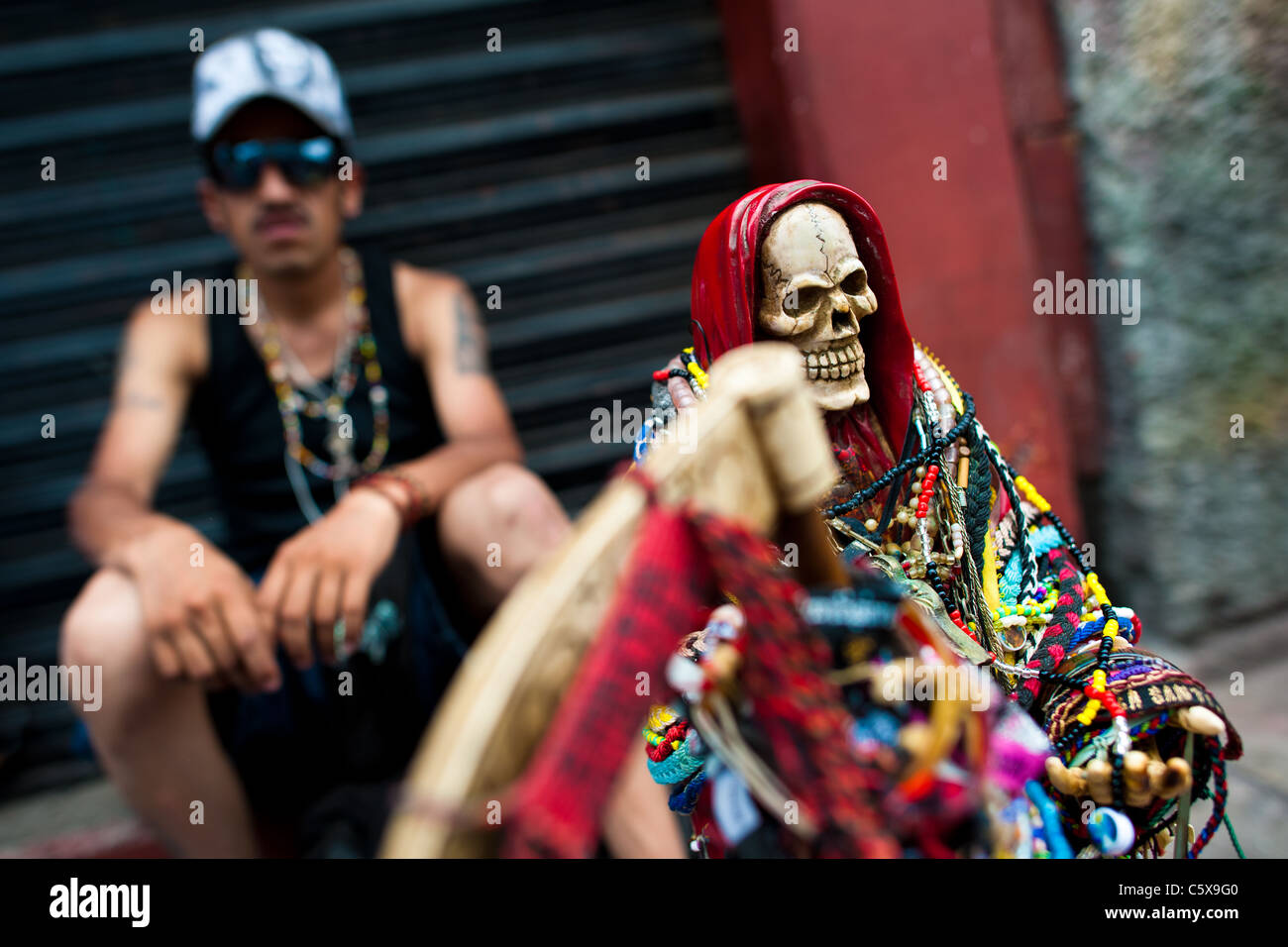 A Mexican follower of Santa Muerte (Holy Death) smokes a marijuana  cigarette during a pilgrimage in Tepito, Mexico City, Mexico Stock Photo -  Alamy