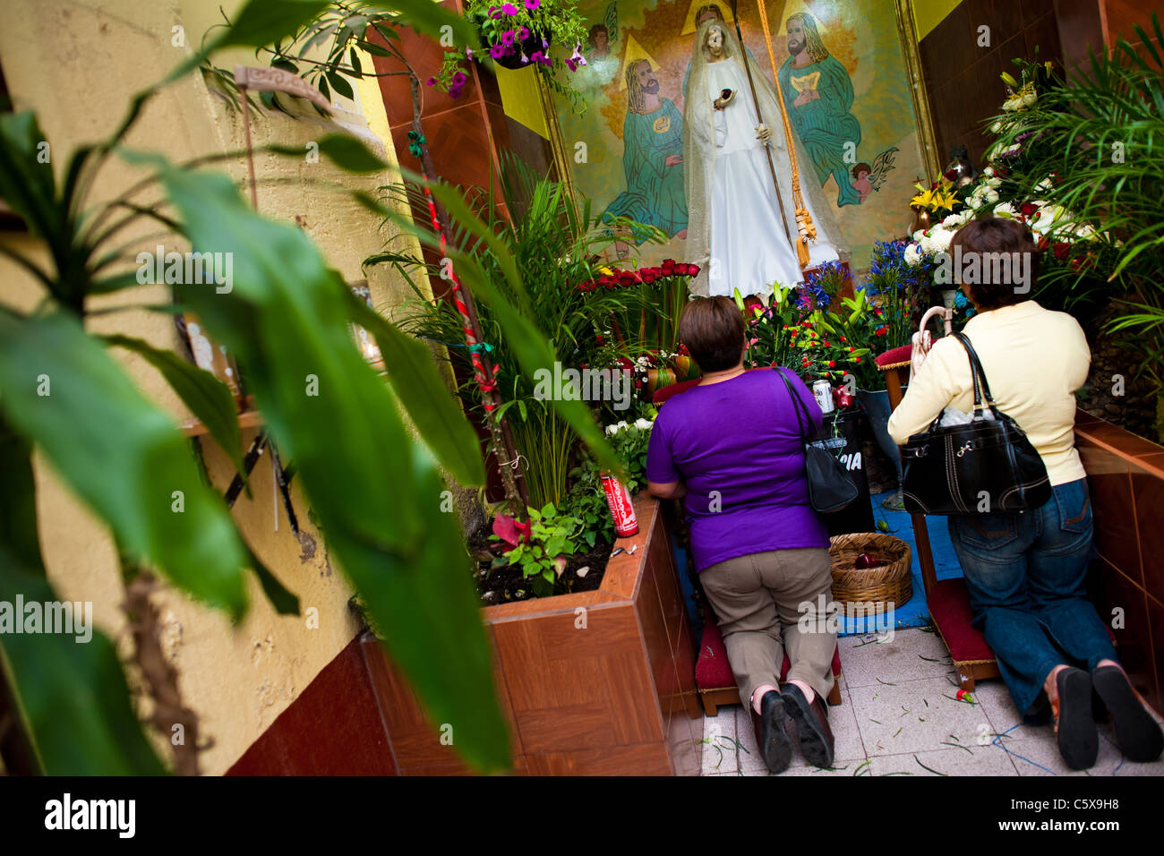 Mexican worshippers of Santa Muerte (Saint Death) pray in a temple in the historical center of Mexico City, Mexico. Stock Photo