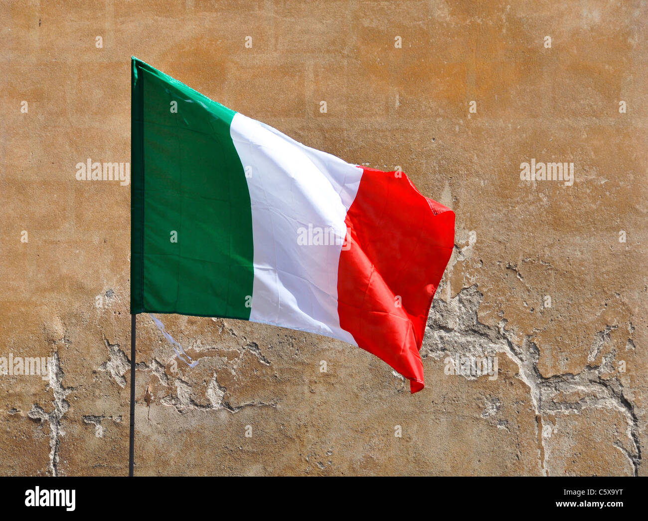 The Italian flag, stone wall background Stock Photo