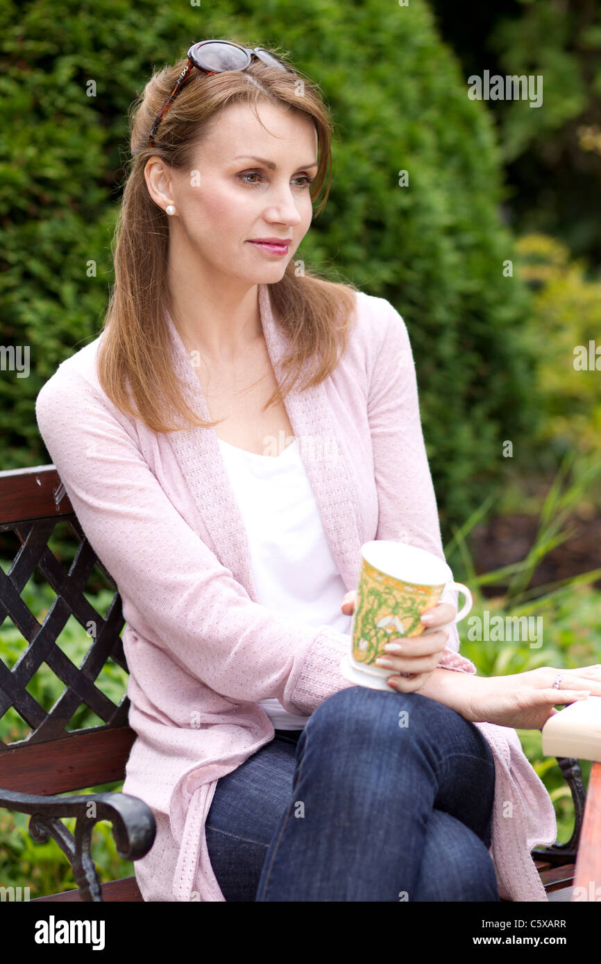 Woman sat in garden with tea hi-res stock photography and images - Alamy