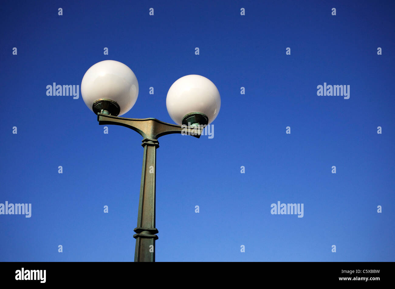 Street lamp against blue sky, low angle view Stock Photo