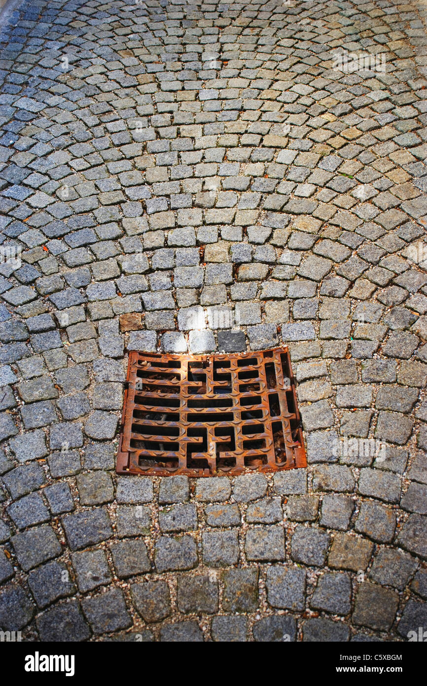 Cobbled pavement, sewer grid, elevated view Stock Photo