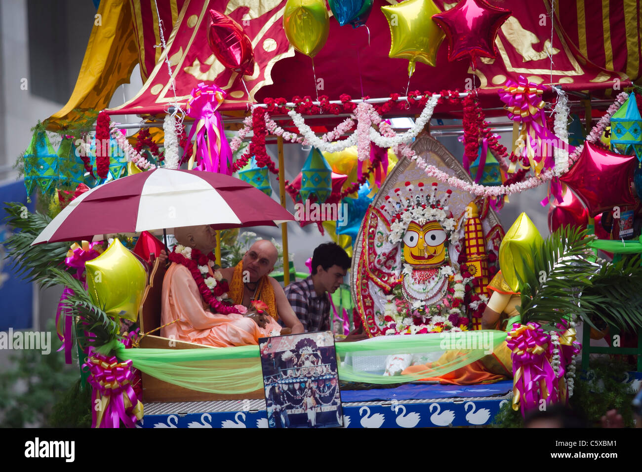 Plastic replica of Krishna founder Swami Prabhupada (left) on a float in the annual Hare Krishna parade in midtown Manhattan Stock Photo
