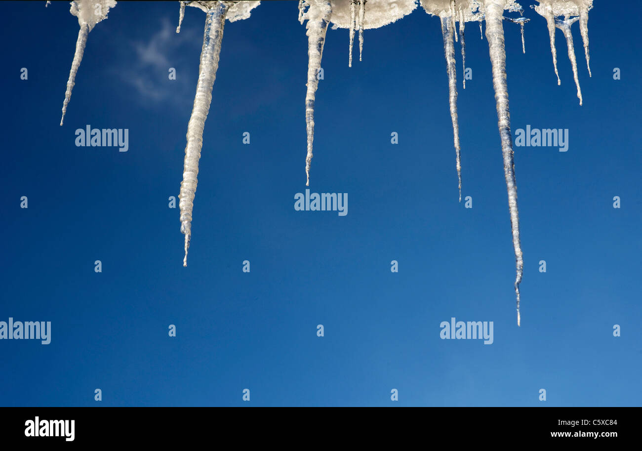 Austria, Icicles against blue sky, low angle view Stock Photo