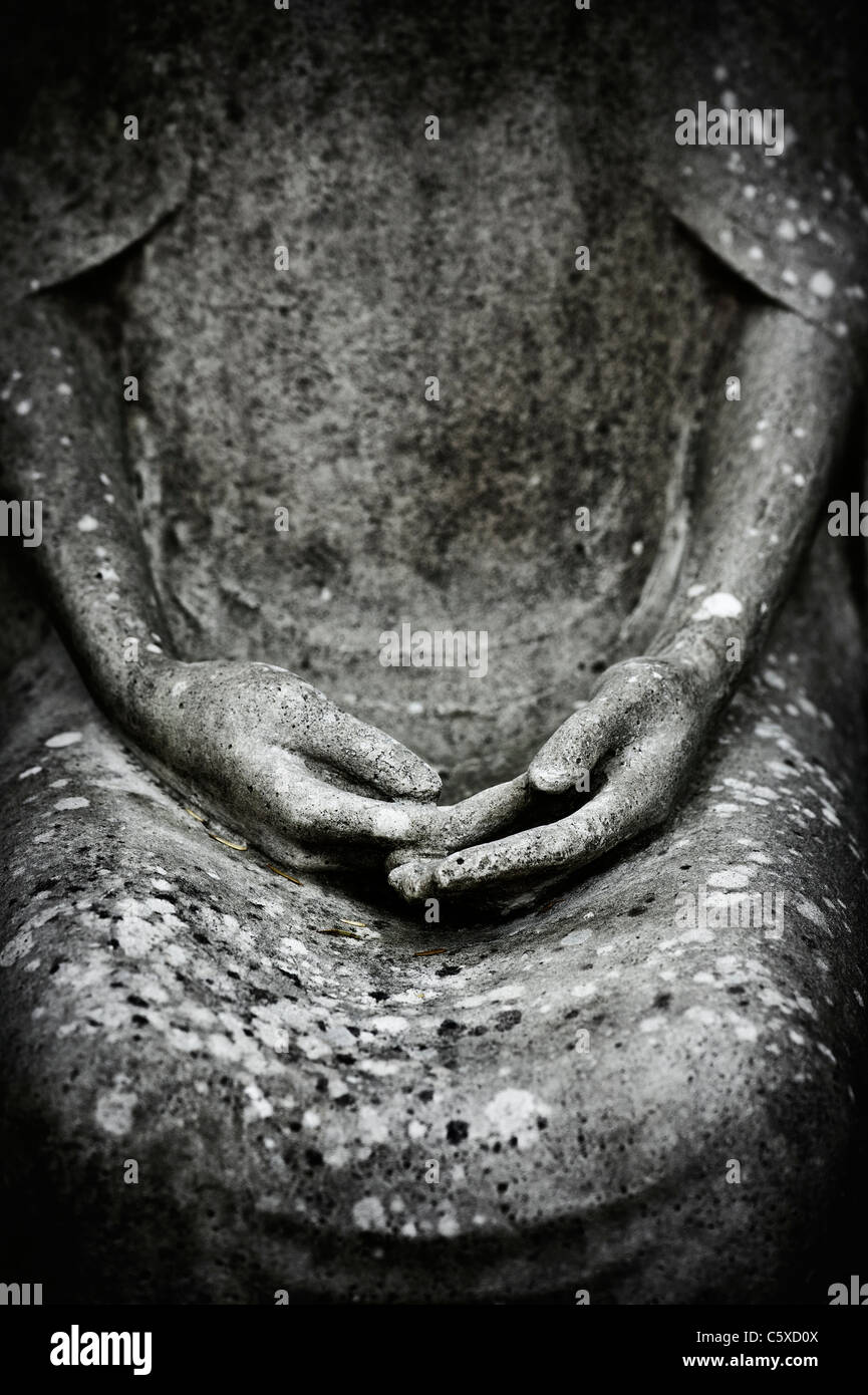 Stone hands on a lap. Garden sculpture / statue abstract at Waterperry gardens, Oxfordshire, England Monochrome Stock Photo