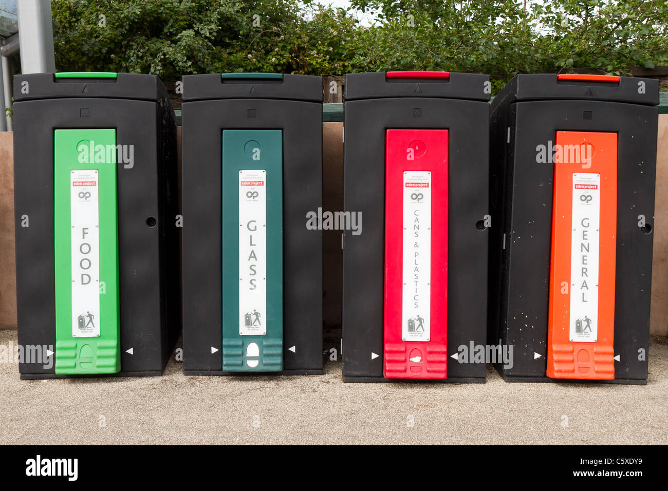 Four black recycling bins in a row at the Eden Project, Cornwall Stock
