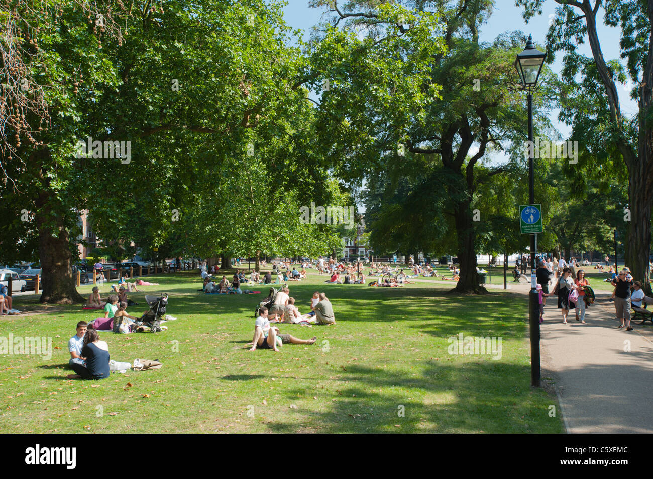 People relaxing in the summer on Parson's Green in West London, England, UK Stock Photo