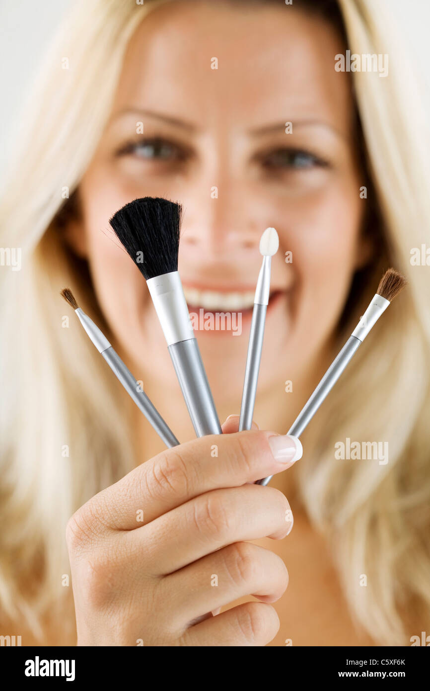 female holding makeup- brushes Stock Photo