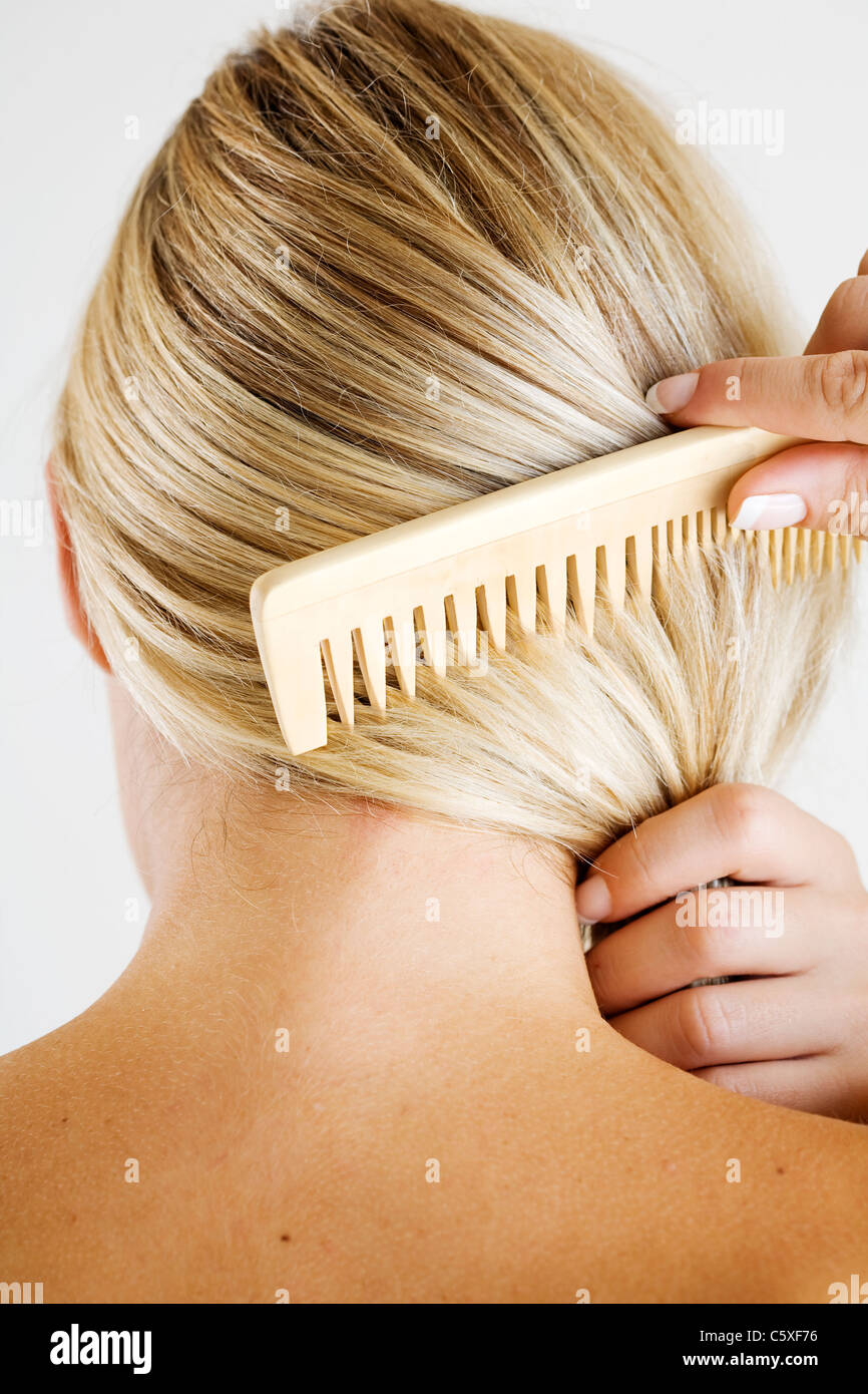 woman combing hair Stock Photo