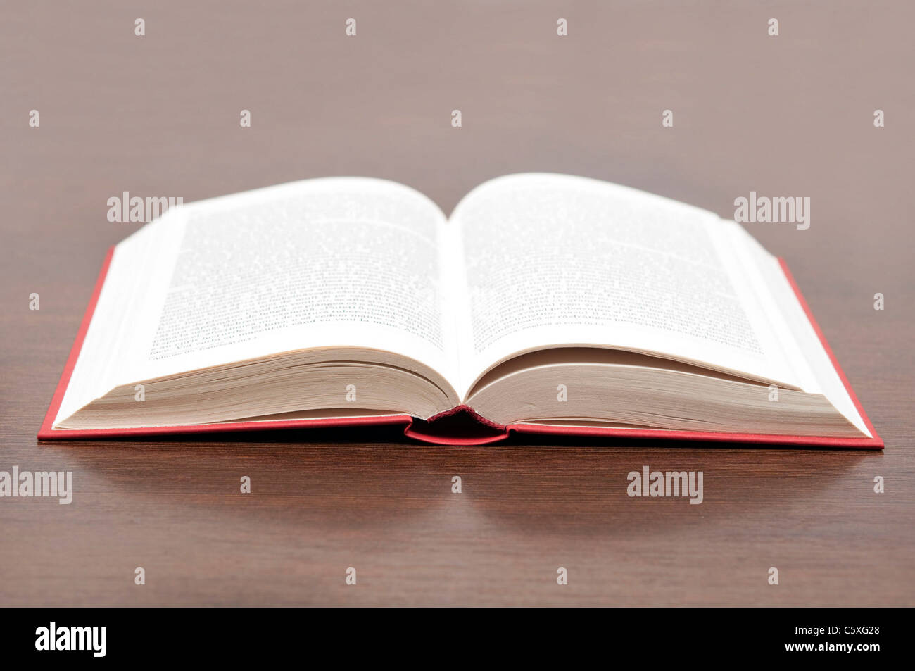 Open book on brown desk Stock Photo