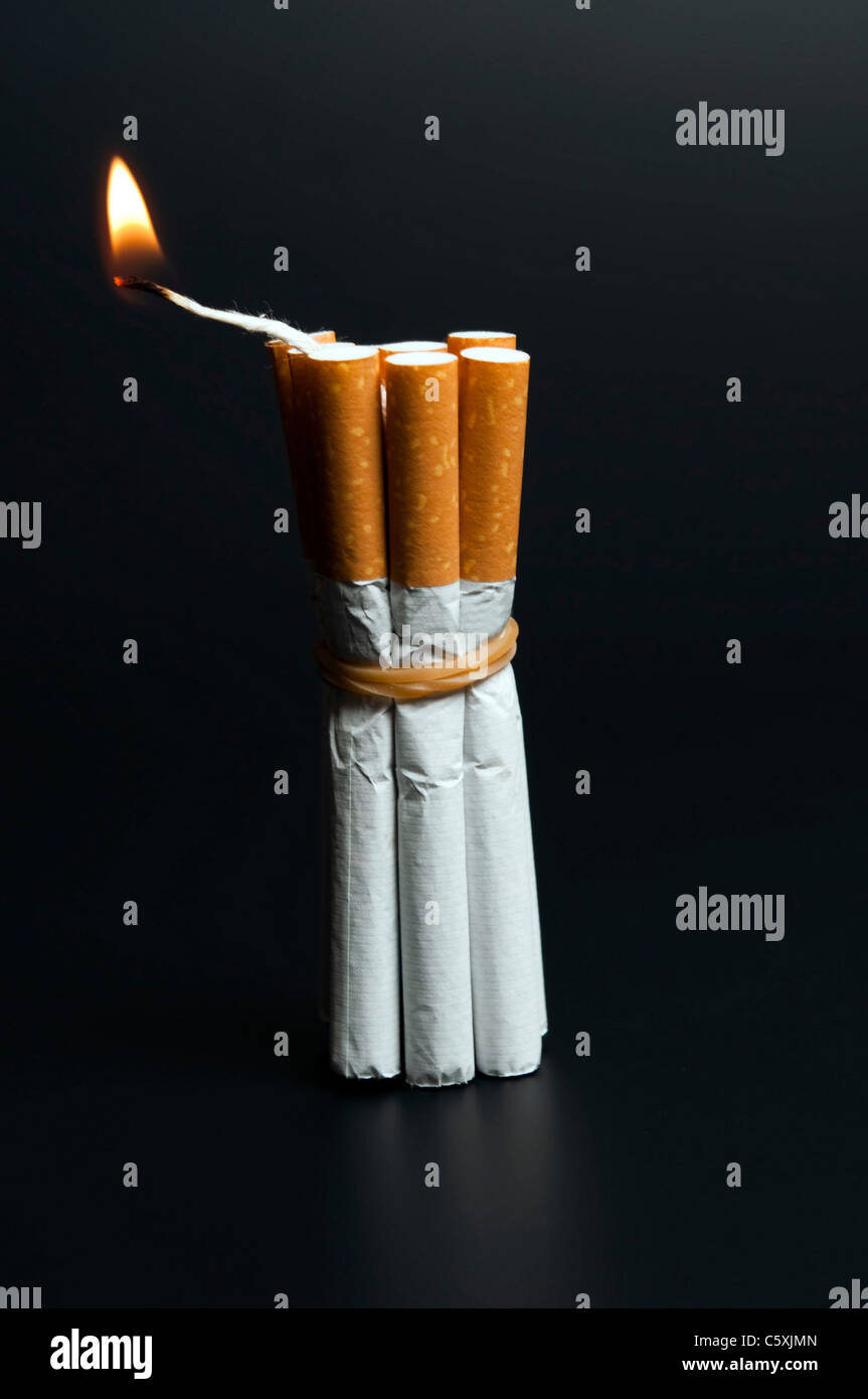Cigarettes in dynamite concept on black Stock Photo