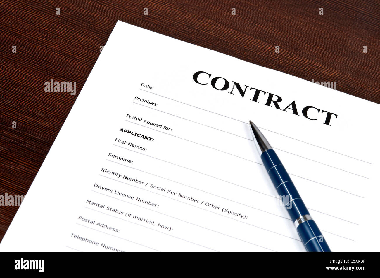 Empty contract and pen on desk Stock Photo