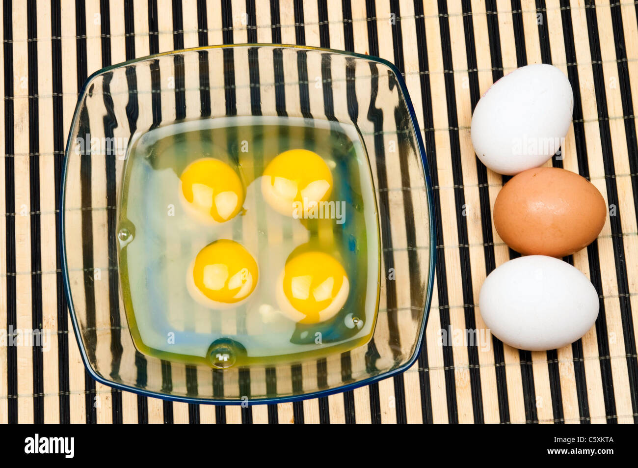 Eggs and yoke in transparent plate Stock Photo