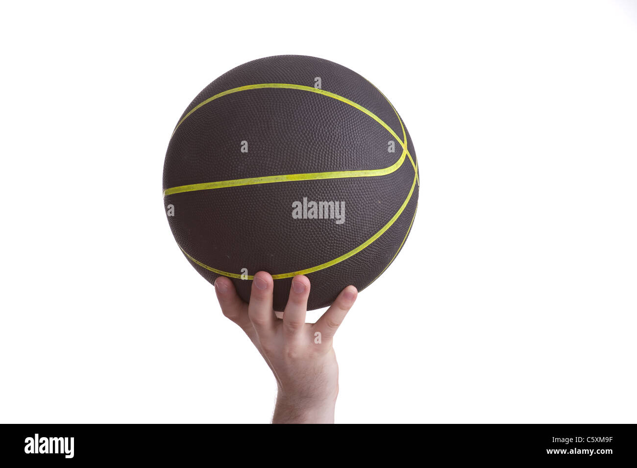 close up of player holding basketball in the air Stock Photo