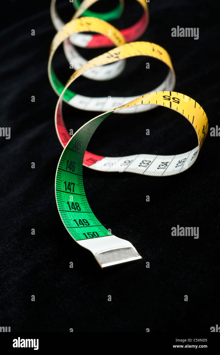 Measurement tape on black material Stock Photo