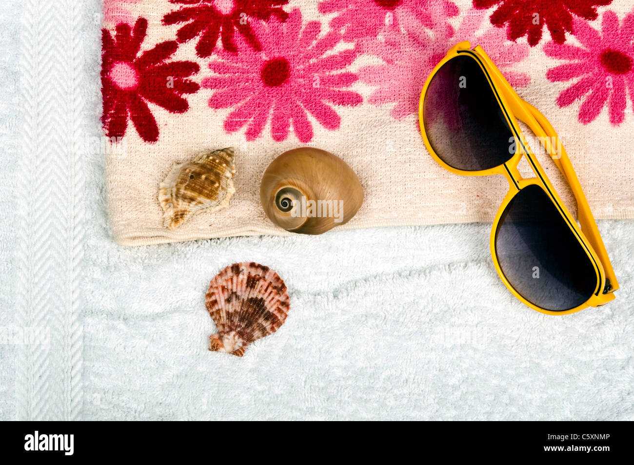 Sun glasses on two towels Stock Photo