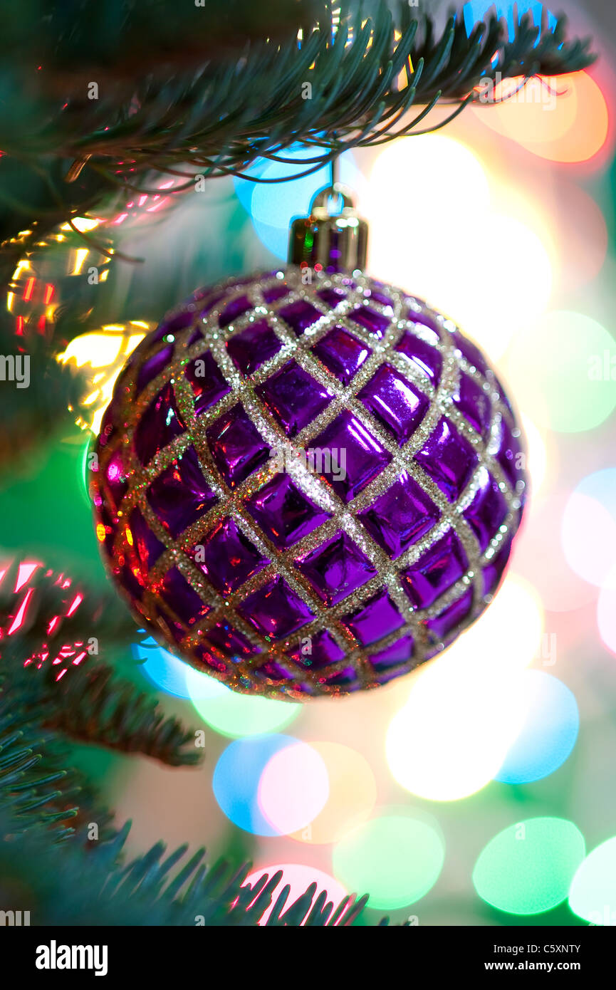 Christmas tree ornament hanging form a Christmas tree with Christmas lights Stock Photo