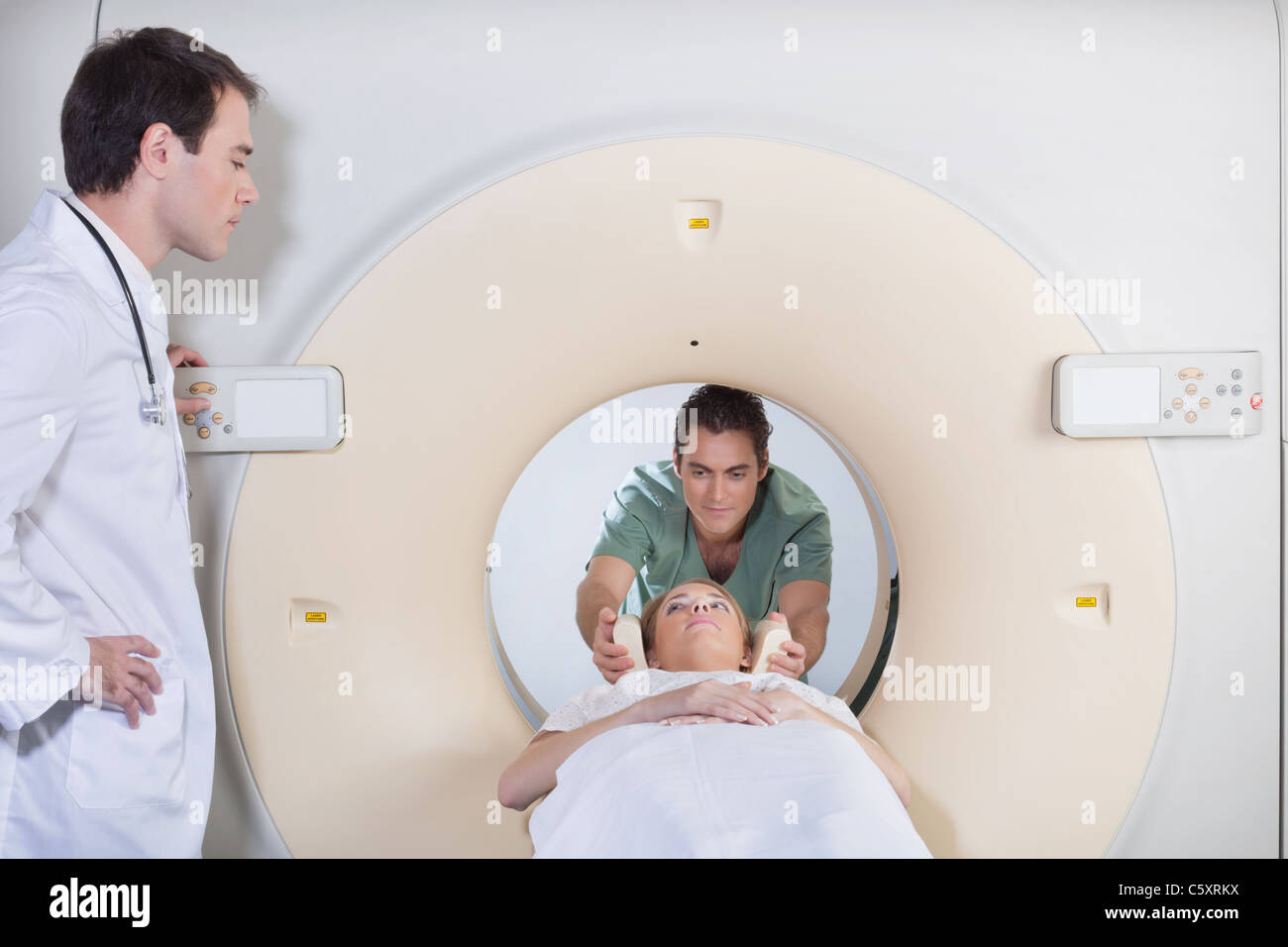 Male nurse preparing patient for CT scan Stock Photo