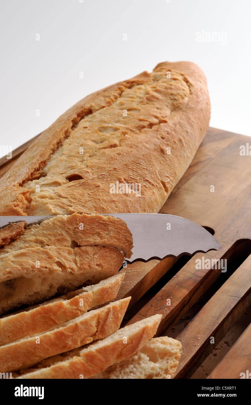 Cutting slices from bread loaf Stock Photo Alamy