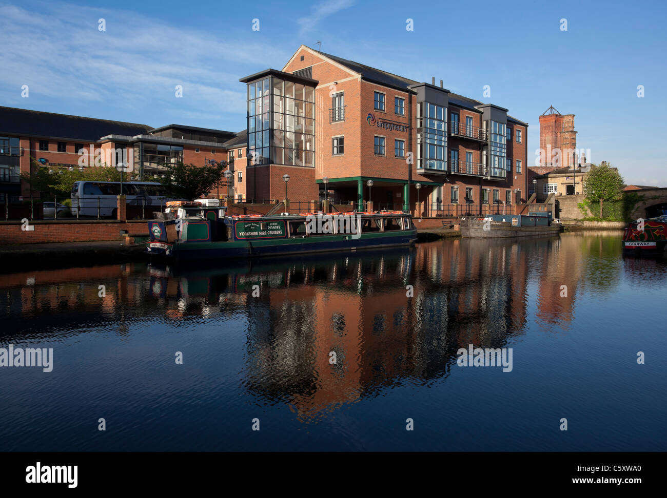 Modern buildings by The River Aire in Leeds, part of the waterfront redevelopment. Stock Photo