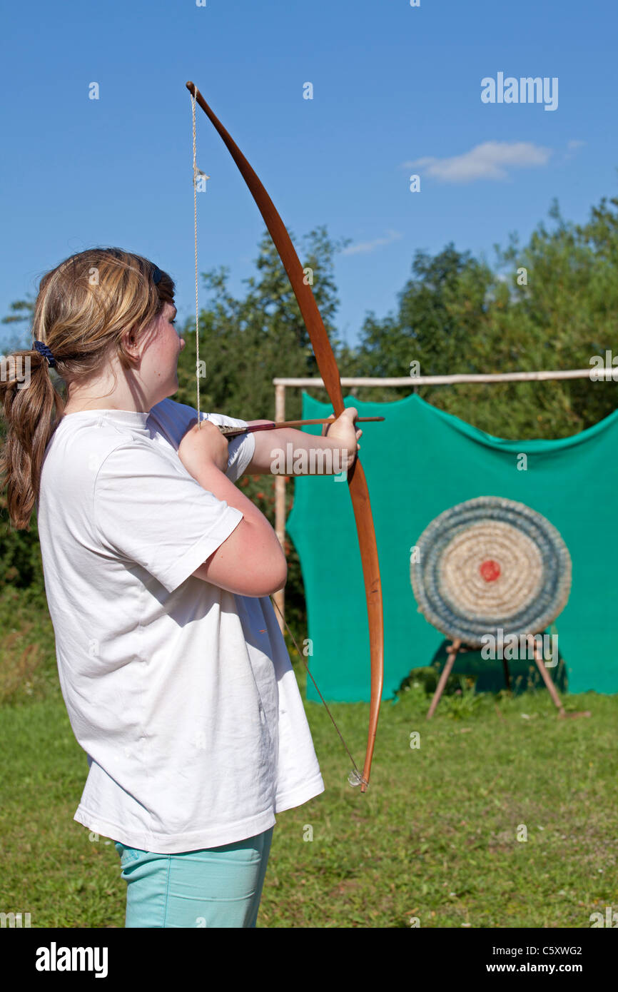 teenage girl practicing archery at Archaeological Centre, Hitzacker, Nature Reserve Elbufer-Drawehn, Lower Saxony, Germany Stock Photo