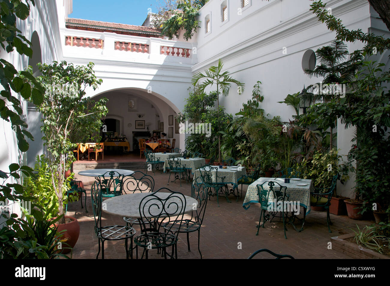Open courtyard dining area the Orient Hotel French Quarter Pondicherry Tamil Nadu South India Stock Photo