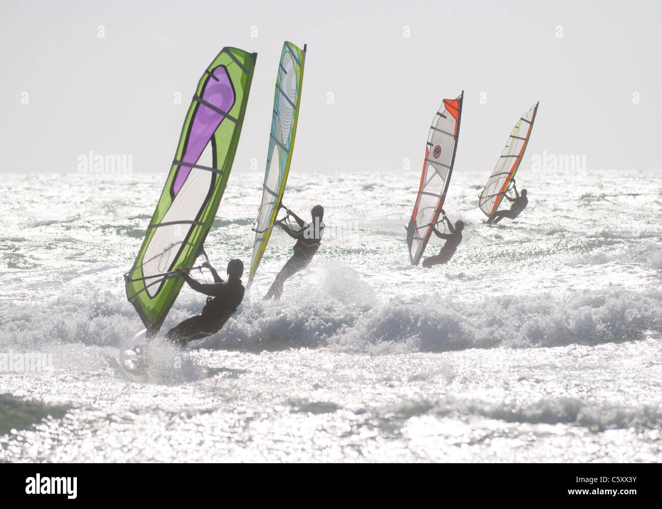 Windsurfing in formation off Guincho Beach near Lisbon, Portugal Stock Photo