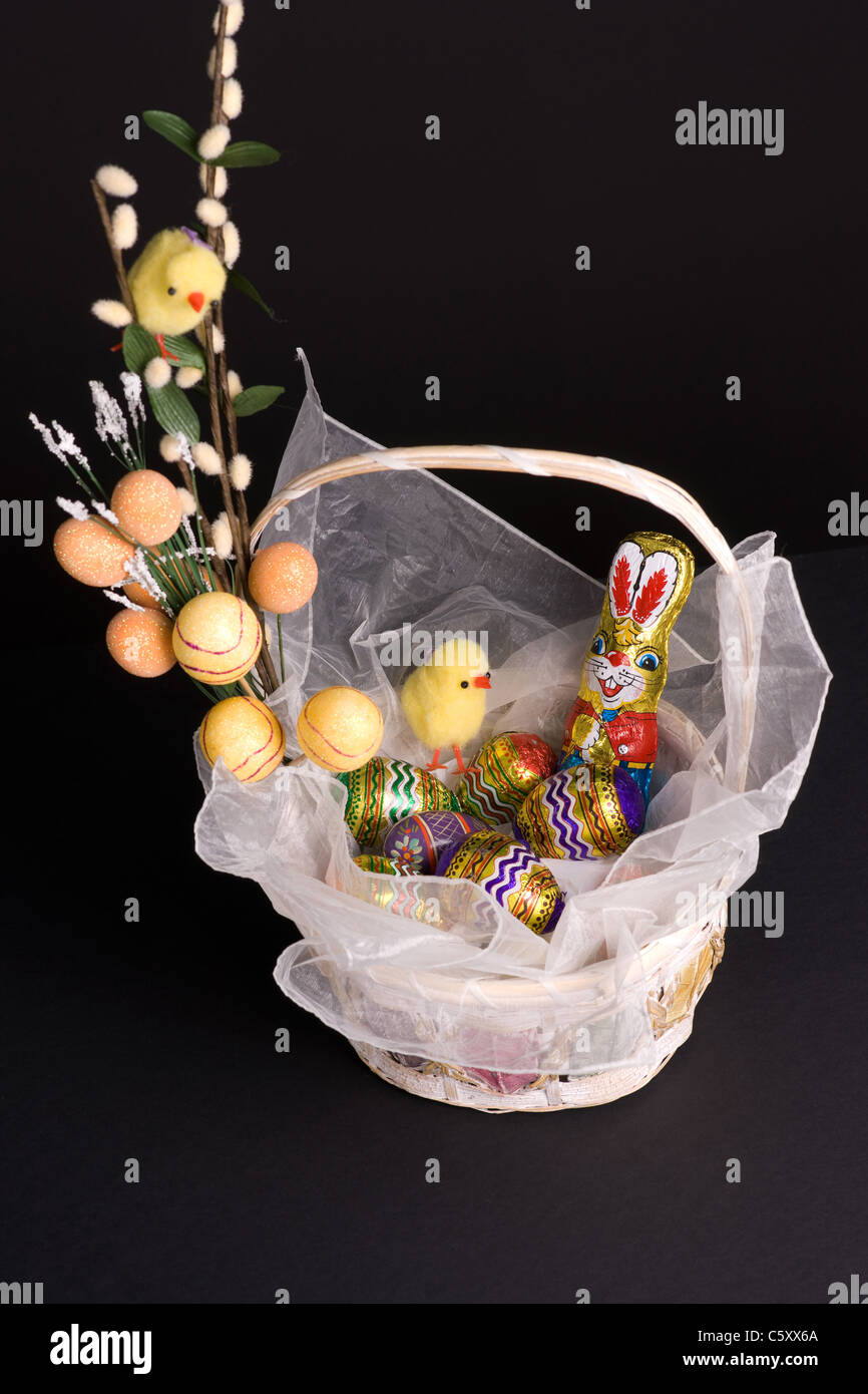 Easter holiday spirit basket with bunny chickens and colored eggs Stock Photo