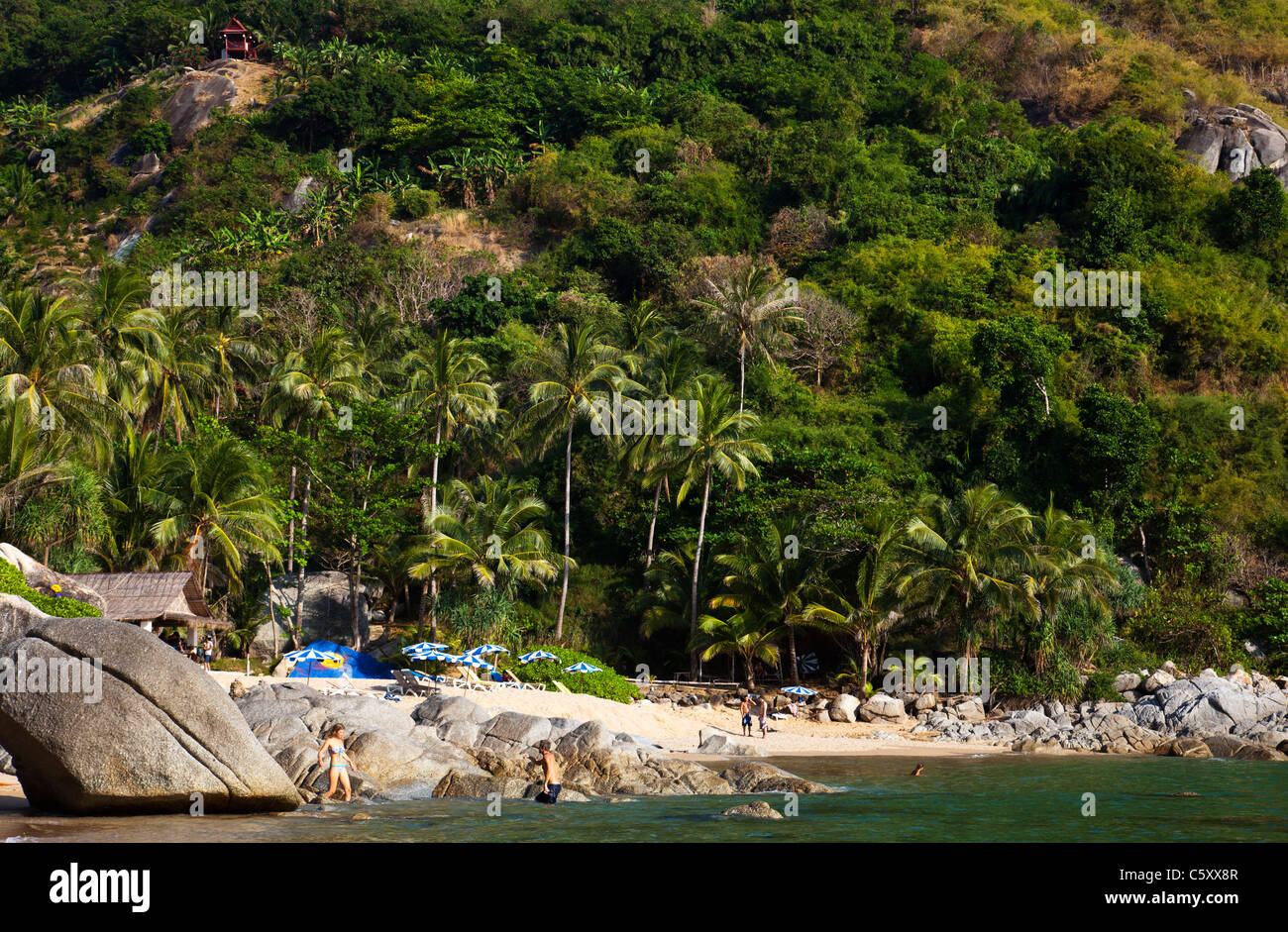 View onto Paradise Beach with rocks and people. Stock Photo