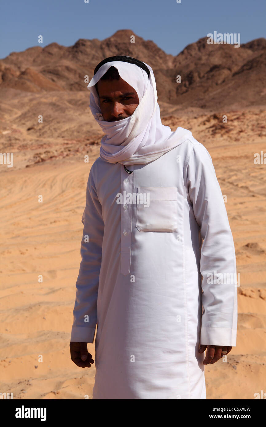 A Bedouin guide stands on sands in the Sinai Desert, Egypt. Stock Photo
