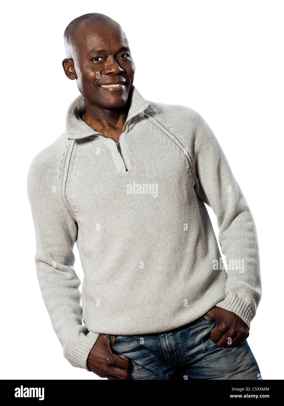 Casual mature afro American man standing smiling in studio with hands in pocket on isolated white background Stock Photo