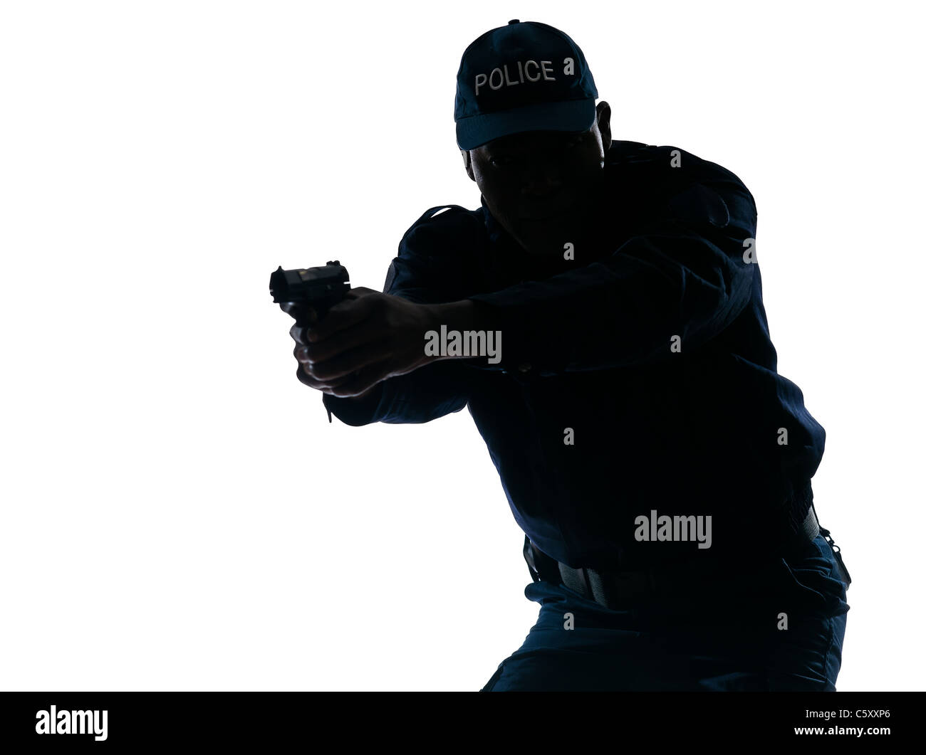 Silhouetted Afro American police officer aiming handgun isolated on white background Stock Photo