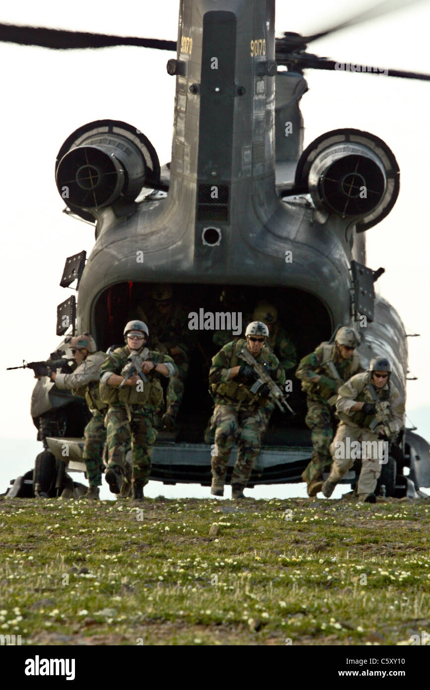 Army aviation unit transports Navy SEALS in CH-47D Chinook helicopter. Stock Photo