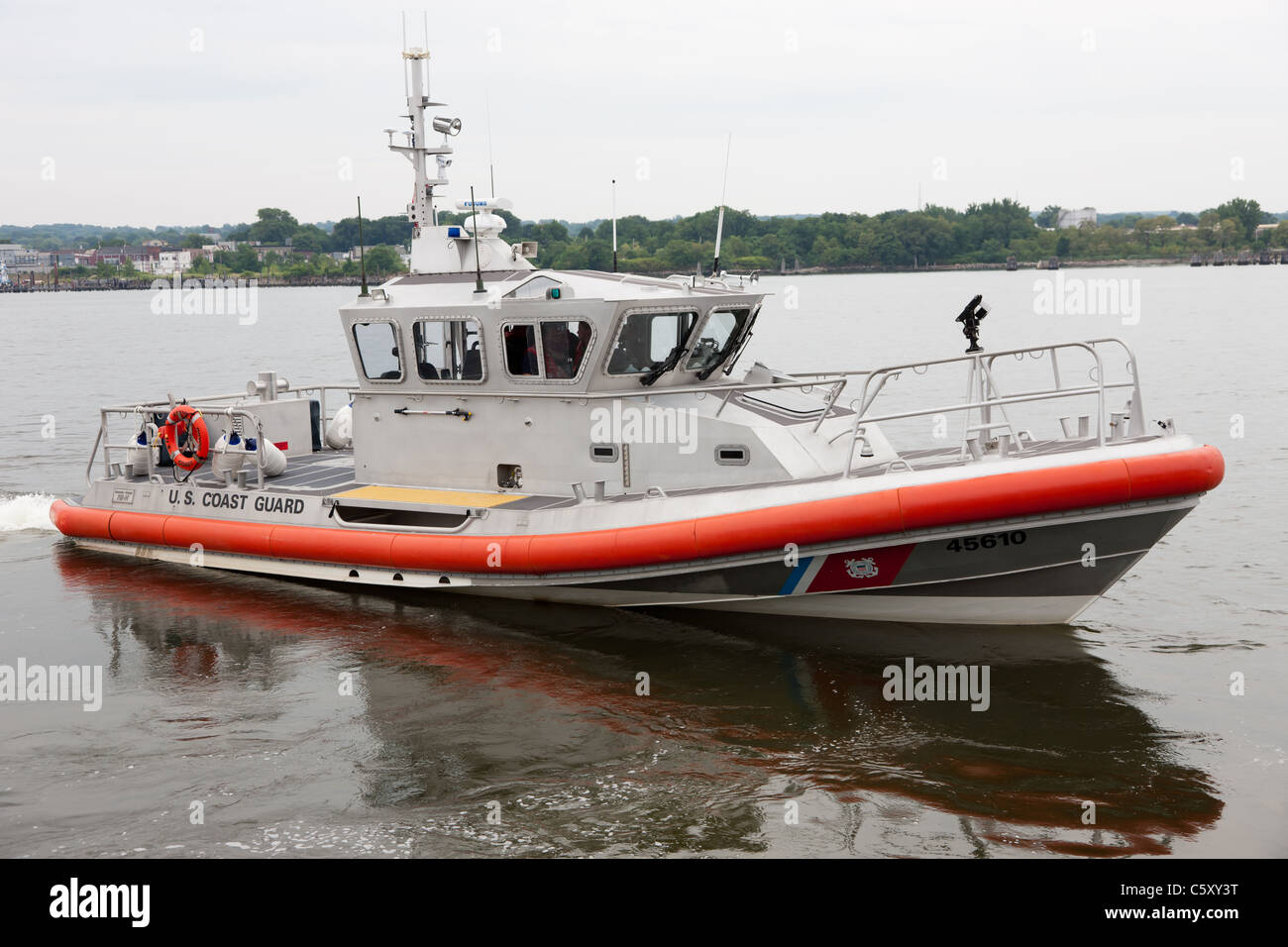 US Coast Guard Response Boat-Medium (RB-M) departs after helping a stranded boater on Kill Van Kull in Bayonne, New Jersey. Stock Photo