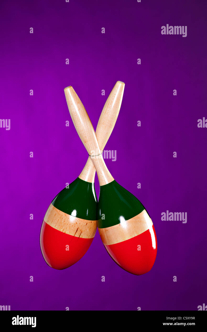 A pair of Latin maracas isolated against a purple background in the
